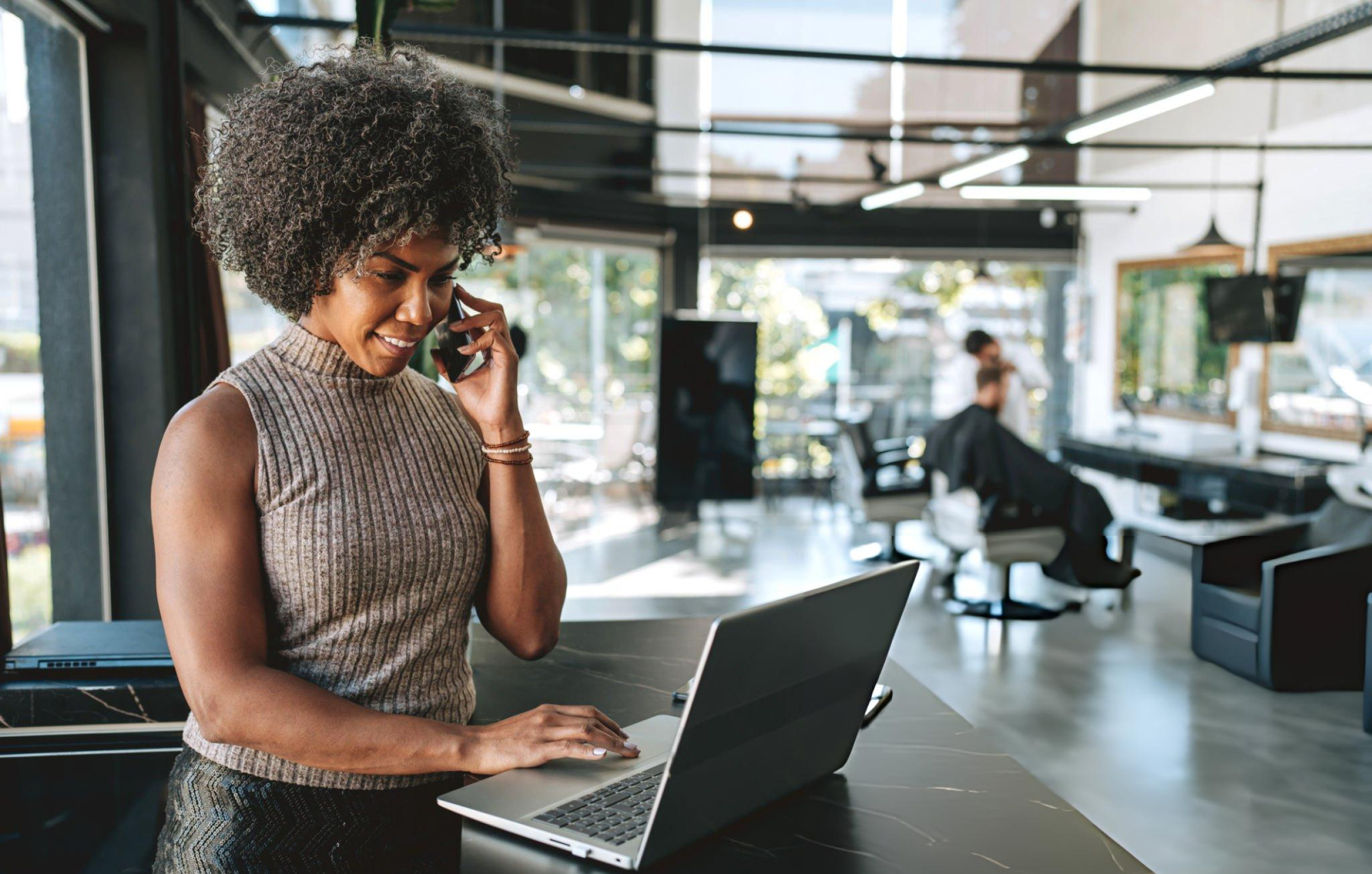 African business professional receiving technology support while working